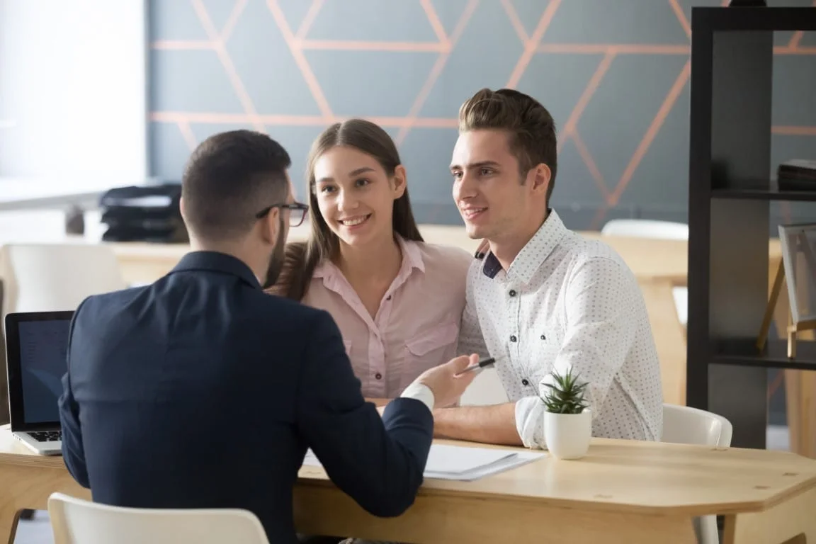 Credit union members applying for a loan with an employee