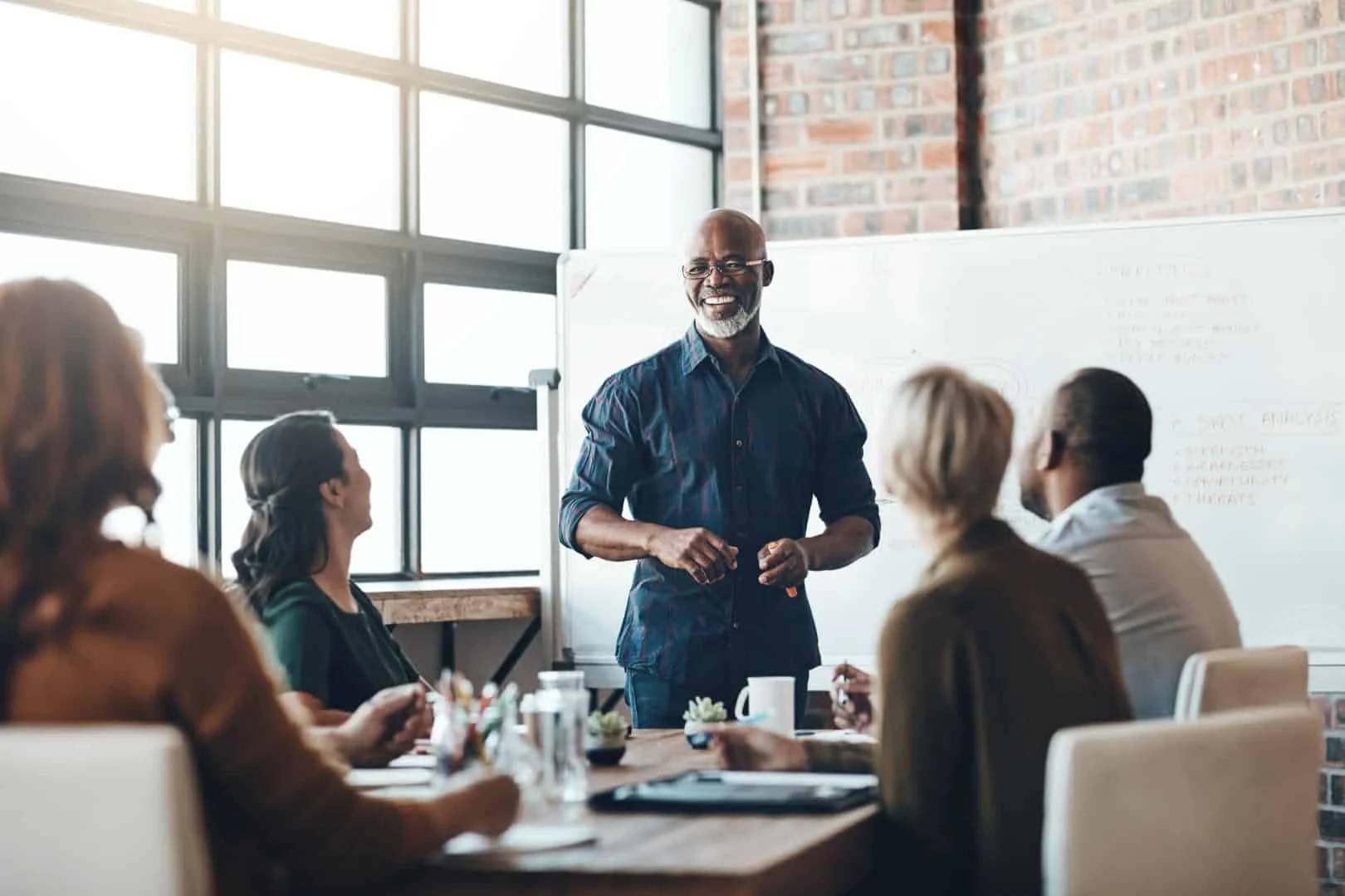 His presentation is motivating. Shot of a businessman giving a presentation to his colleagues in a boardroom.